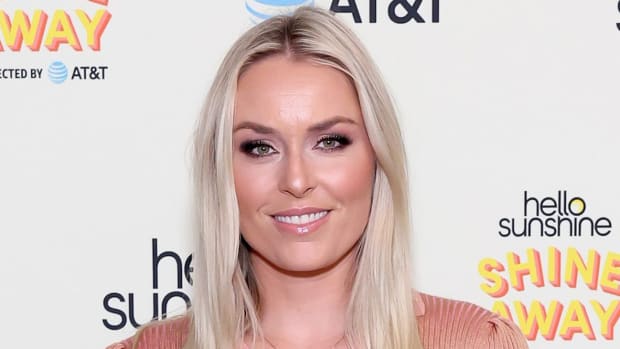 Lindsey Vonn poses in a blush-colored dress and wears her blonde hair down.