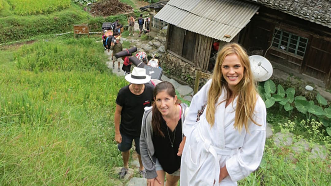 Anne V, Darcie and the crew hike to a location in China while shooting for the 2013 issue.