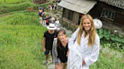 Anne V, Darcie and the crew hike to a location in China while shooting for the 2013 issue.