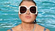Martha Stewart was photographed by Ruven Afanador in the Dominican Republic. Sunglasses by Gucci provided by Moda Operandi. Necklace by Cicada.