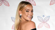 Georgia Gibbs smiles over her shoulder in a black off-the-shoulder dress.