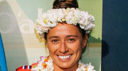 Malia Manuel poses in a Lei and a flower crown and smiles for the camera.