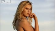 Maria Sharapova poses in a bikini and stares at the camera.