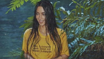 Kim Kardashian was photographed by Greg Swales in the Dominican Republic. Swimsuit by SKIMS. Top by Saint Luis vintage. 