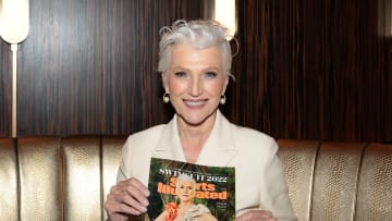 Maye Musk holds her cover issue of SI Swimsuit 2022.