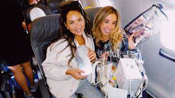 Christen Harper and Katie Austin going through their gift bags.