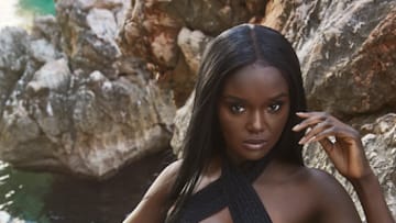 Duckie Thot was photographed by James Macari in Montenegro. Swimsuit by HAUS OF PINKLEMONAID. Bracelet by MONIES provided by New York Vintage.