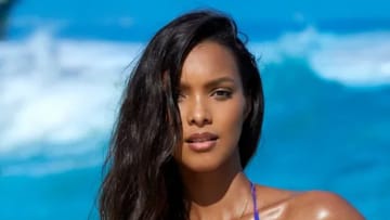 Lais Ribeiro poses before the bright blue ocean in a vibrant string bikini.