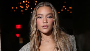 Olivia Ponton poses in a blazer and wears her dirty blonde hair down.
