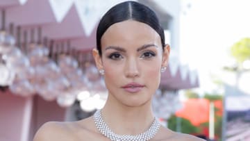 Sofia Resing poses for the camera in a diamond necklace and a slicked-back hairstyle.