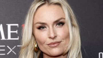 Lindsey Vonn sports her light blonde hair in a layered down-do and smiles softly for the camera.