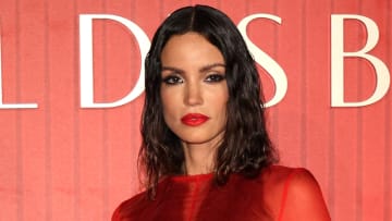 Sofia Resing poses in a red mesh gown and red lipstick.