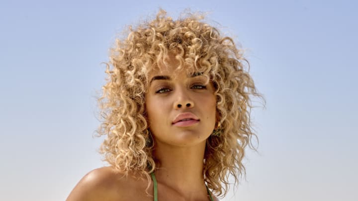 Jasmine Sanders was photographed by Yu Tsai in Belize. Swimsuit by Juan de Dios. Earrings by ANNELE.