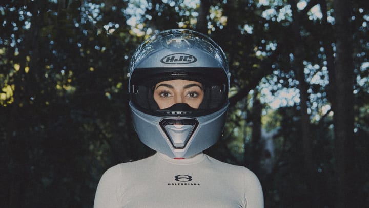 Kim Kardashian was photographed by Greg Swales in the Dominican Republic. Swimsuit by SKIMS. Top by Balenciaga. Helmet by HJC.