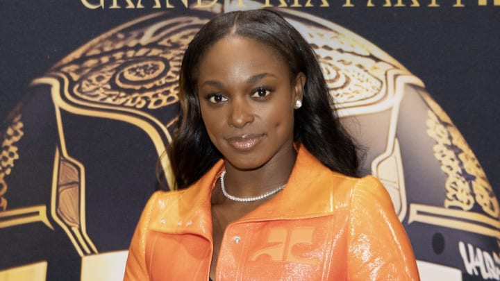 Sloane Stephens poses in an orange sparkly blazer jacket and silver diamond necklace.