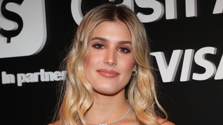 Genie Bouchard wears her blonde hair in a soft curl and sports a pink glossy lip and a diamond necklace. Genie Bouchard wears her blonde hair in a soft curl and sports a pink glossy lip and a diamond necklace.