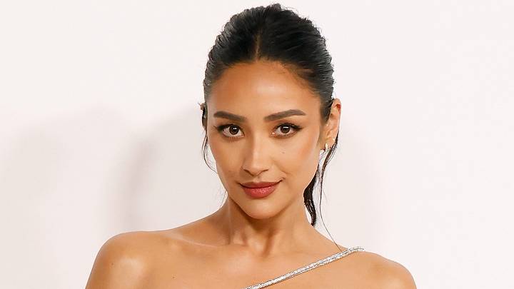 Shay Mitchell poses in an off-the-shoulder dress and a slicked back up-do. Shay Mitchell poses in an off-the-shoulder dress and a slicked back up-do.