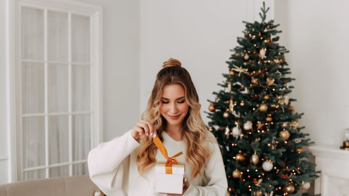 Woman opening gift Woman opening gift