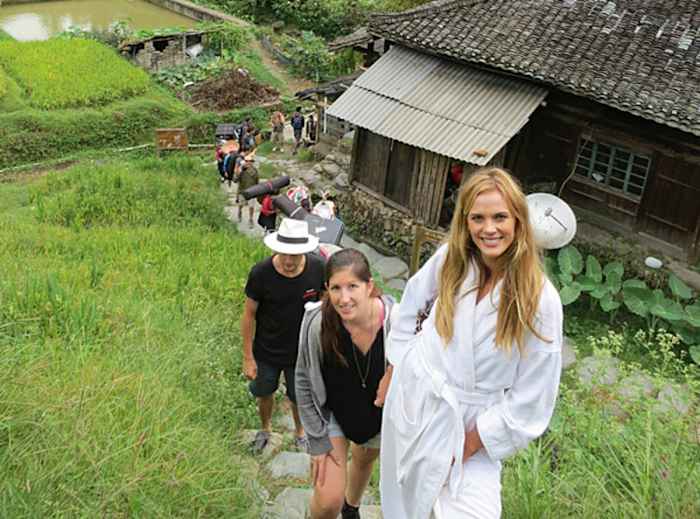 Anne V, Darcie and the crew hike to a location in China while shooting for the 2013 issue.