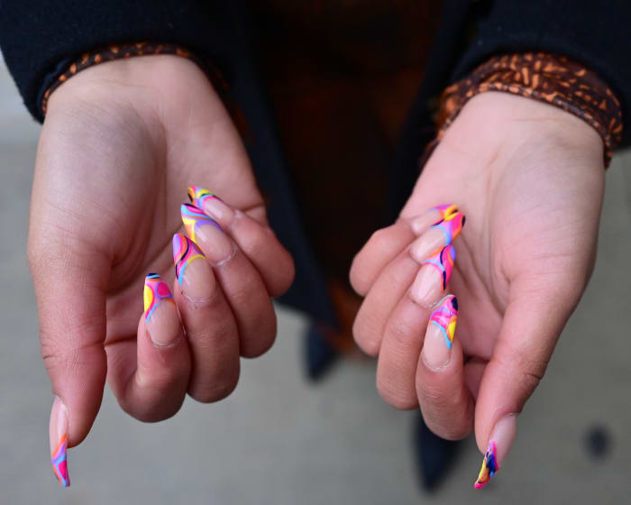 A guest displays graphic, Pucci-inspired nail art at Spring Studios at New York Fashion Week.