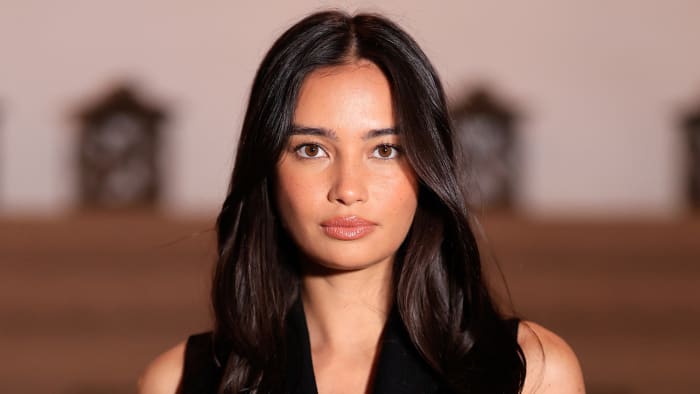 Kelsey Merritt Is on Island Time in Stunning Black One-Piece and Straw Hat