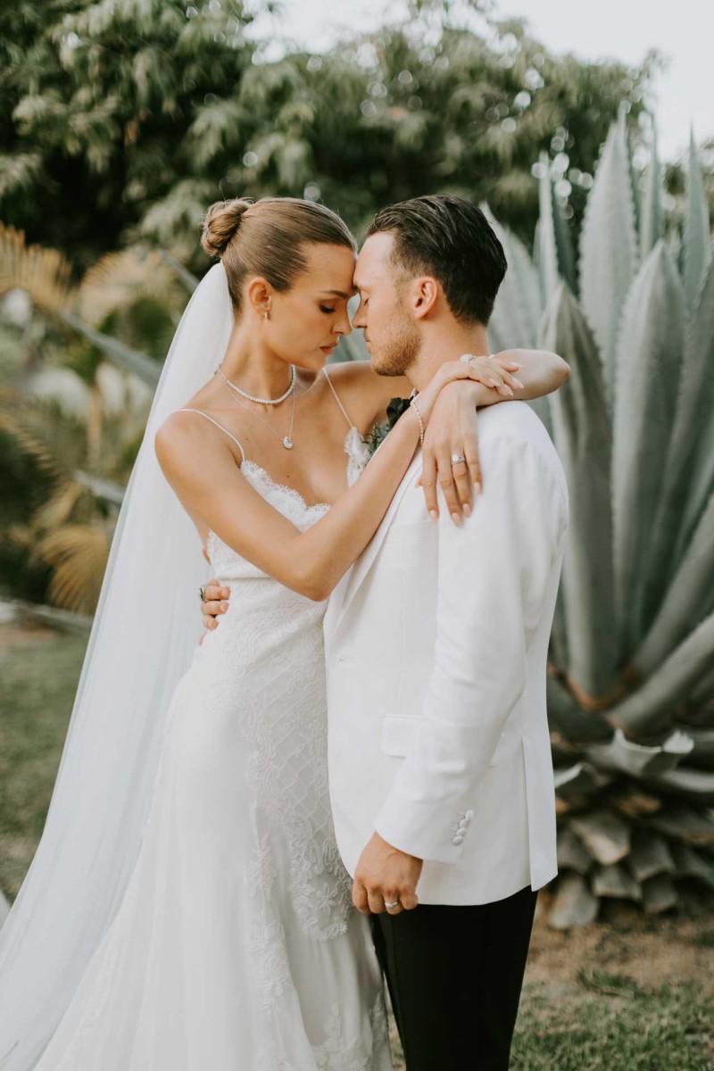 A tender embrace after the ceremony. Jewelry by Logan Hollowell, custom dress by Alberta Ferretti