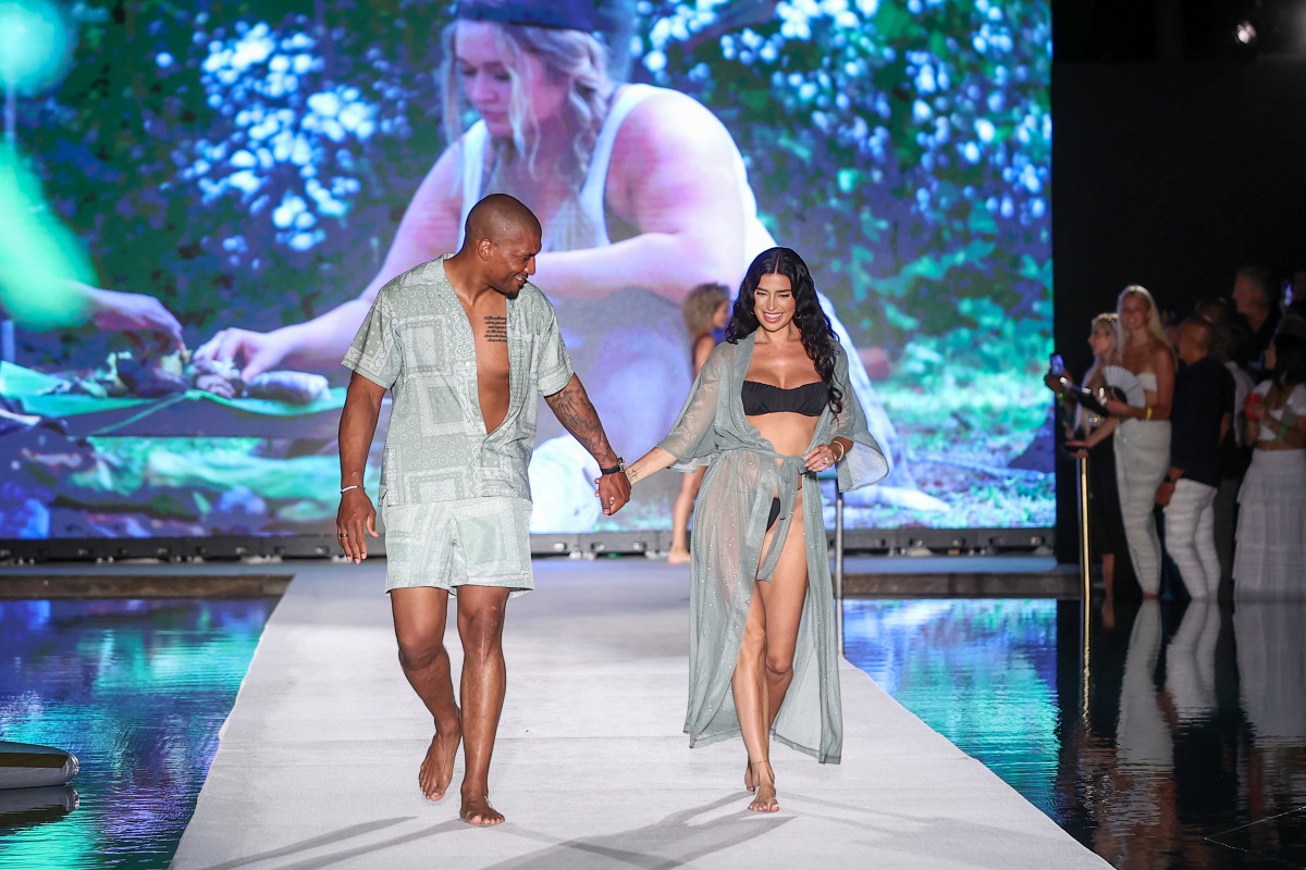 Larry English and Nicole Williams English walks the runway for Sports Illustrated Swimsuit Runway Show During Paraiso Miami Beach on July 16, 2022 in Miami Beach, Florida. 