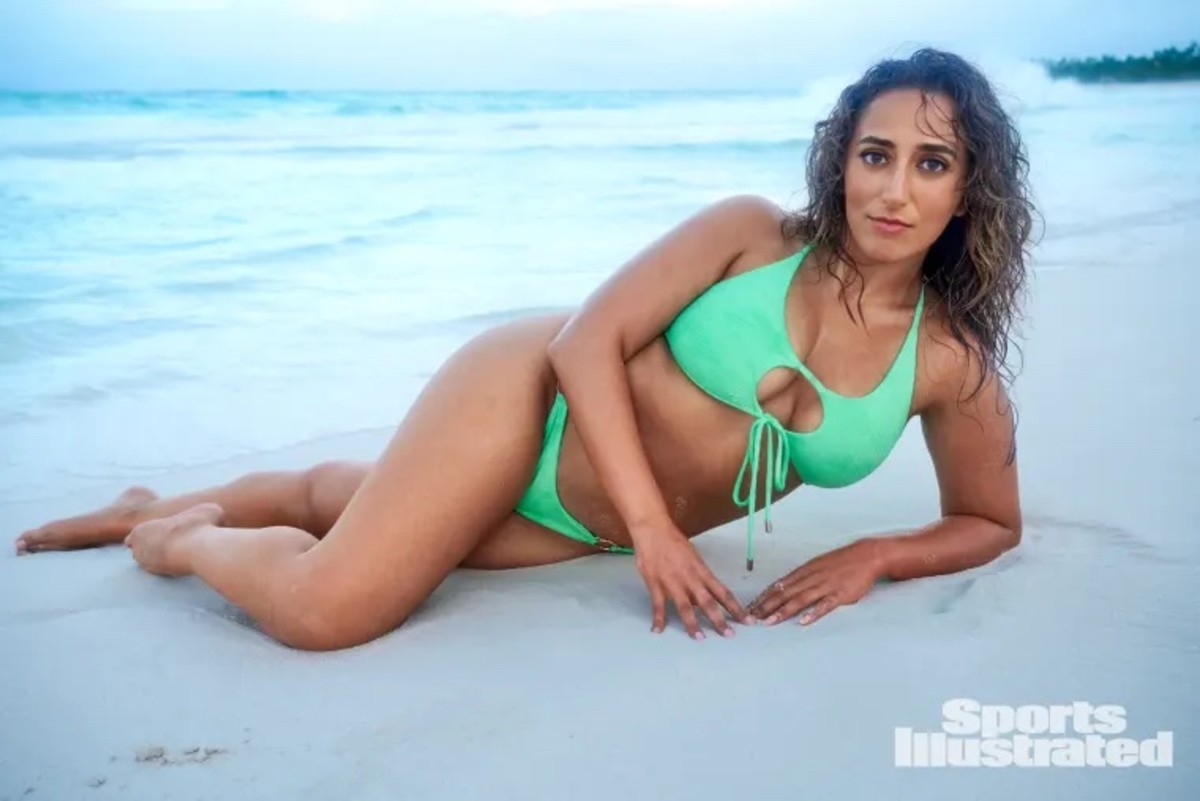 Sarafina El-Badry Nance lays on the beach in a green bikini with a front cut-out.