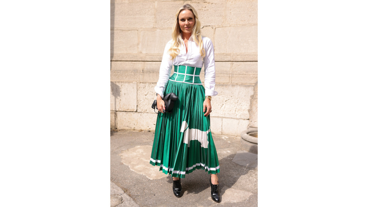 Lindsey Vonn poses in white button-down and green silk skirt.