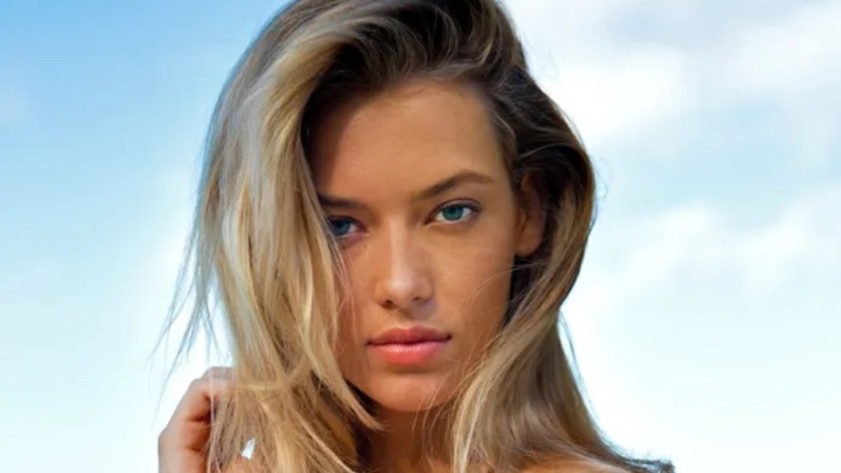 Hannah Ferguson poses with her hair down in front of her face and stares at the camera.