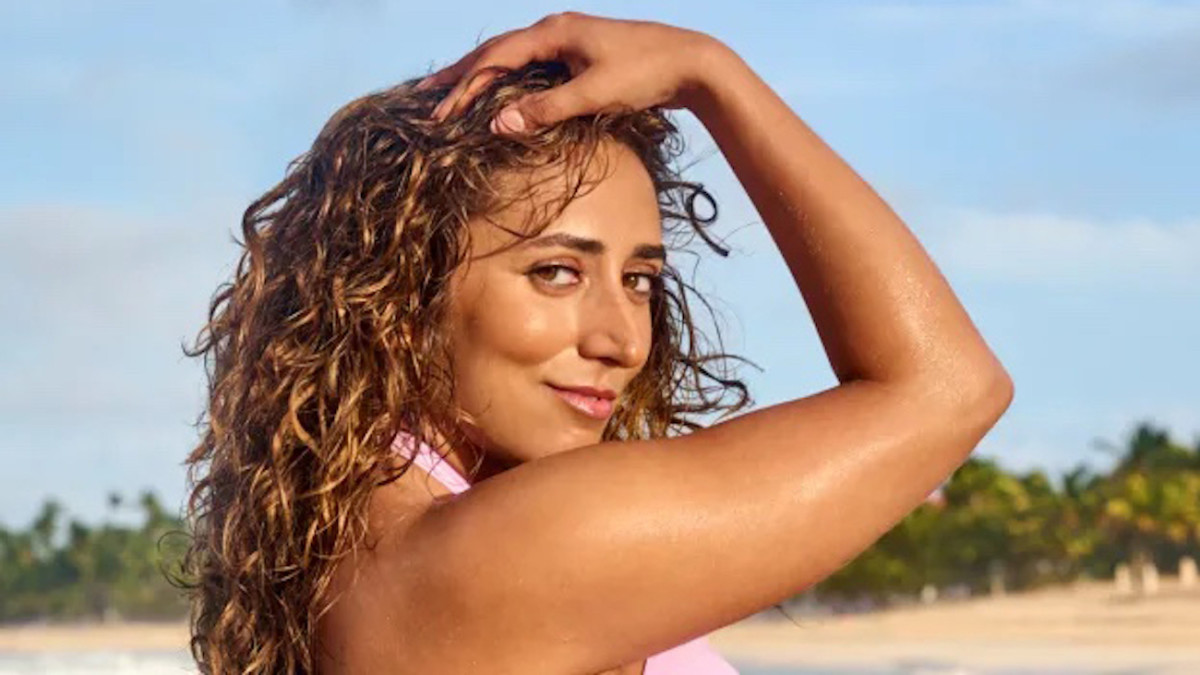 Sarafina El-Badry Nance poses in a pink bikini with her hand on her head.